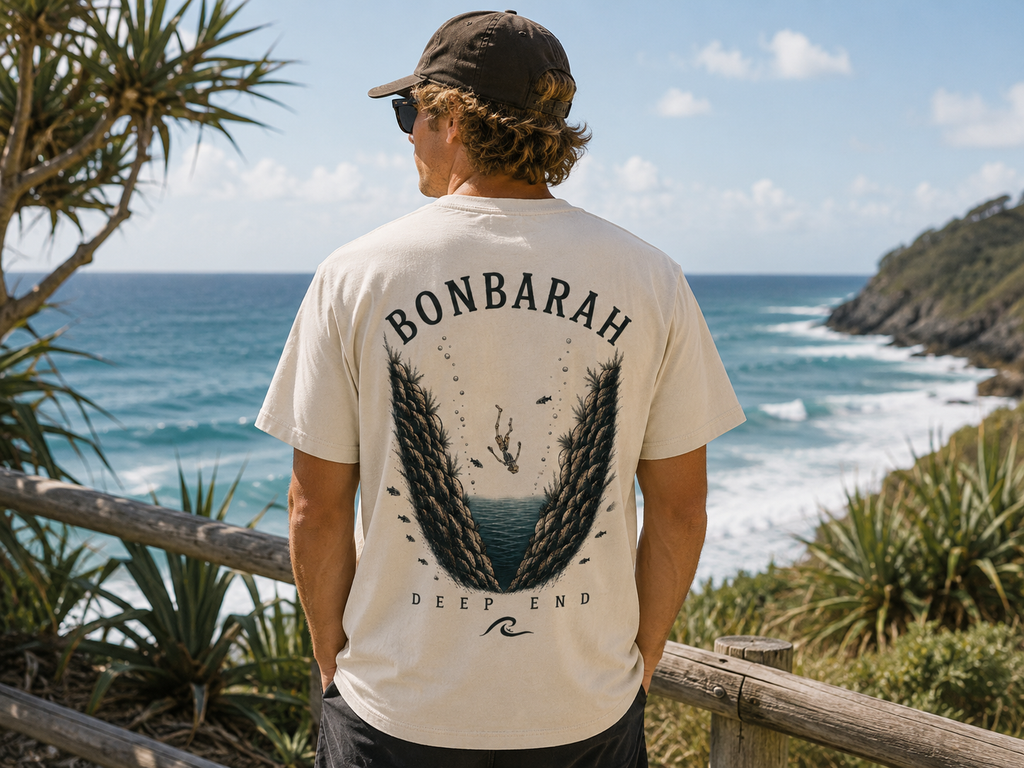 Deep End Shirt in Off White - back graphic worn at beach