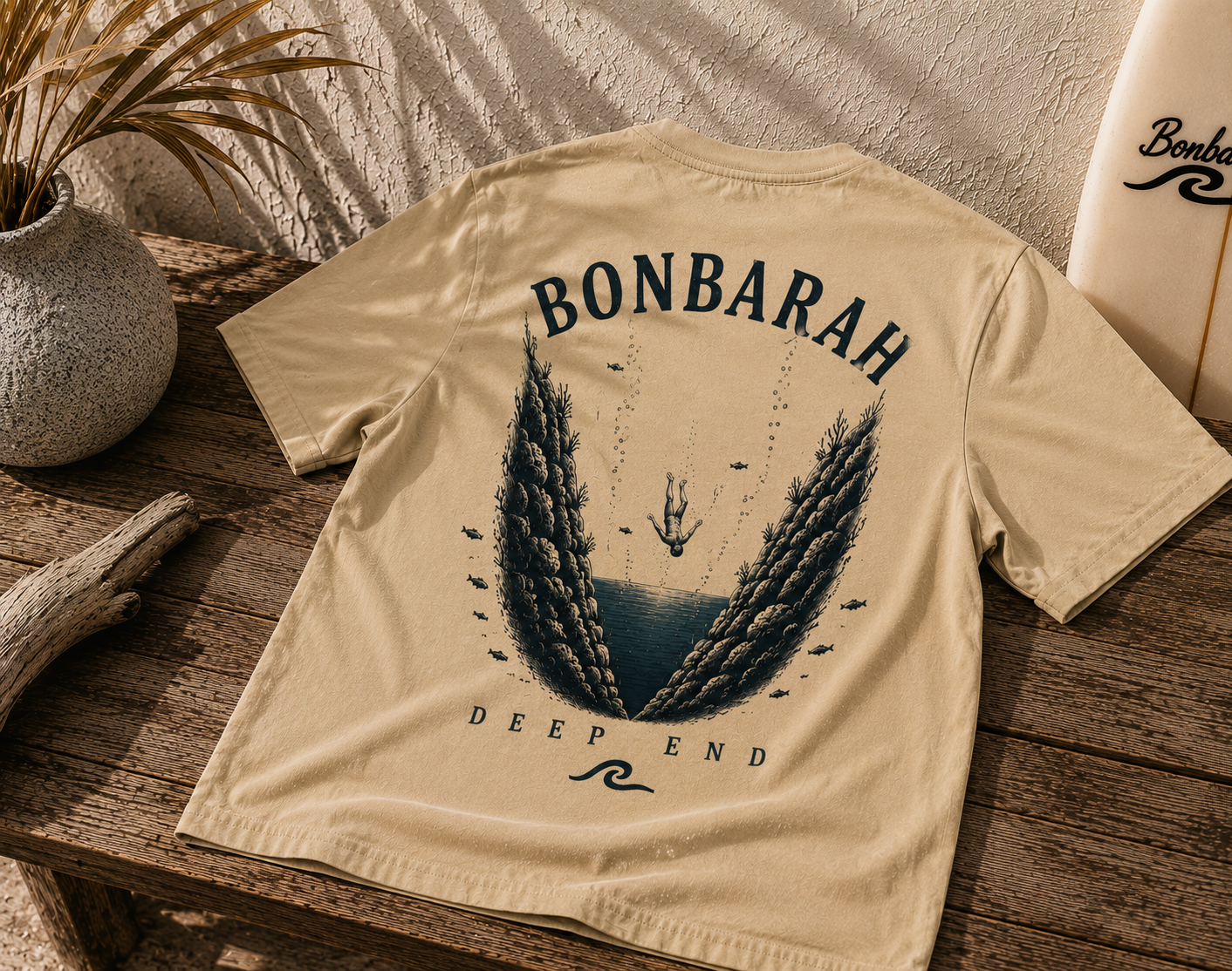 Deep End Shirt in Sand - back graphic on timber surface