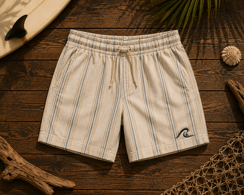 Coastal Stripe Shorts flat lay on timber showing cream linen pinstripe and embroidered wave logo