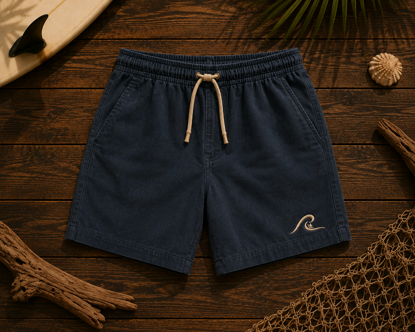 Ocean Fade Shorts flat lay on timber showing washed navy fabric and embroidered wave logo