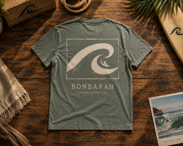Dune Wash Tee flat lay showing back wave graphic on wooden surface
